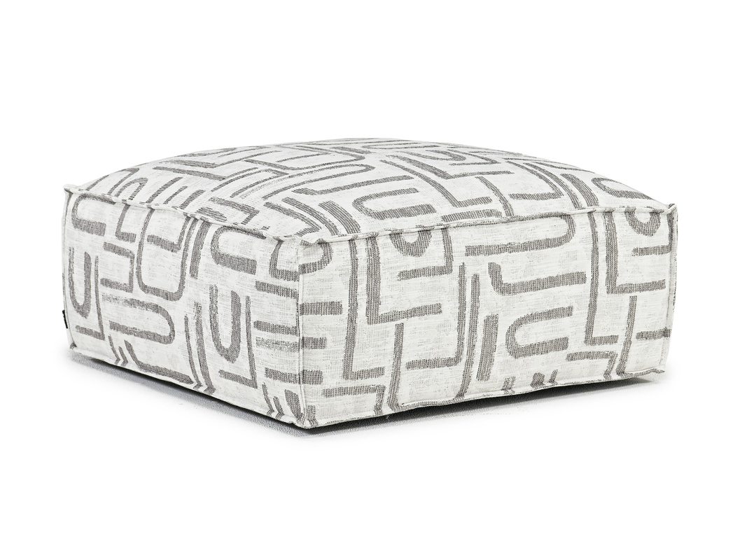 Ivory accent ottoman with gray J, U, and L-shaped patterns.